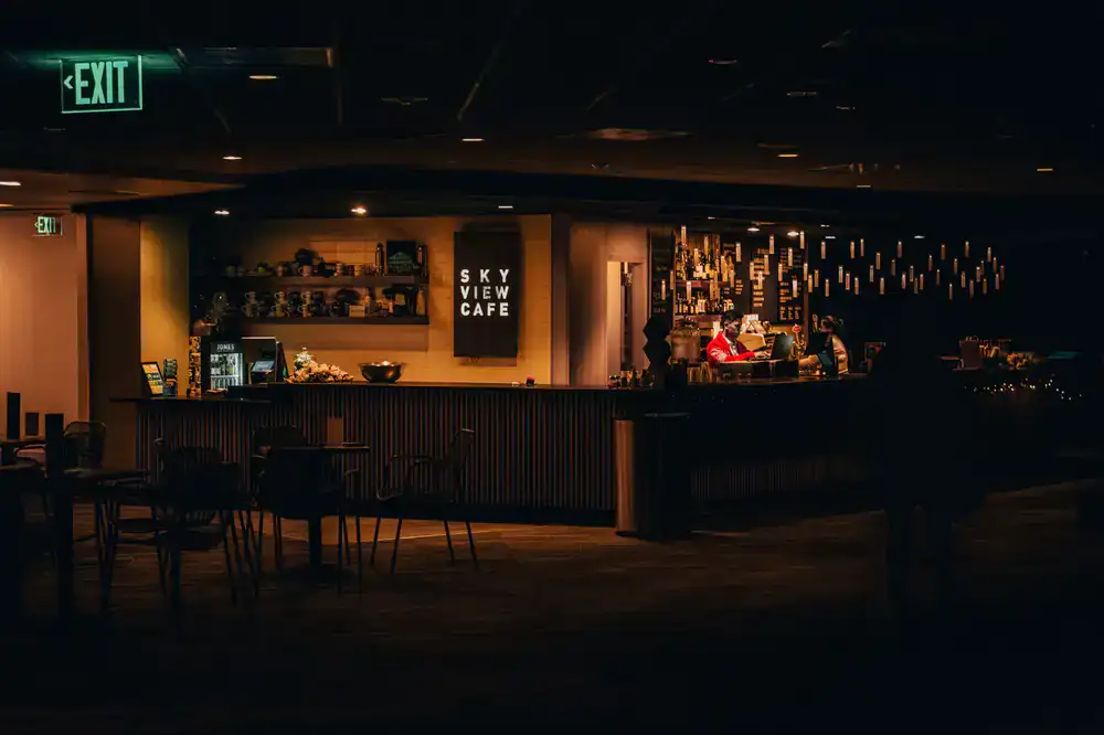 A modern, warmly lit storefront interior featuring multiple aquariums
